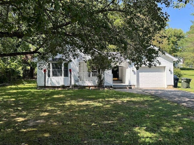 view of property hidden behind natural elements featuring a garage and a front lawn