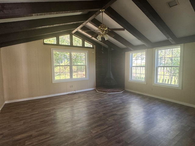 interior space featuring ceiling fan, wooden walls, dark hardwood / wood-style flooring, and lofted ceiling with beams