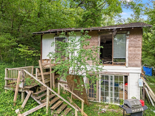 rear view of property featuring an outbuilding