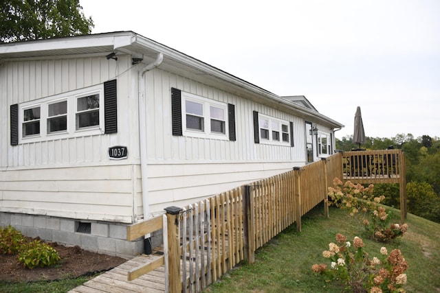 view of property exterior with a deck