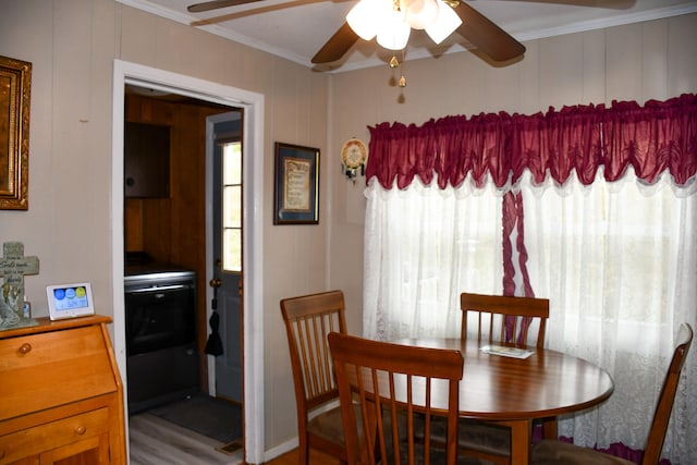 dining room featuring ornamental molding, wood-type flooring, and ceiling fan