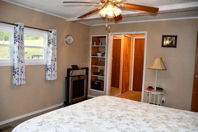 carpeted bedroom with ceiling fan and crown molding