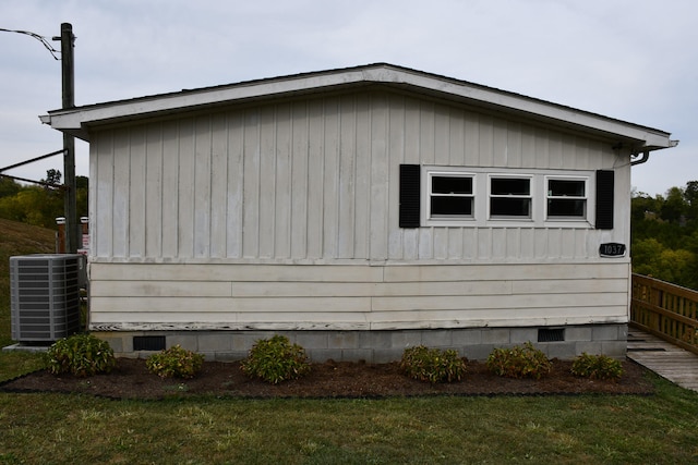 view of home's exterior with a yard and cooling unit