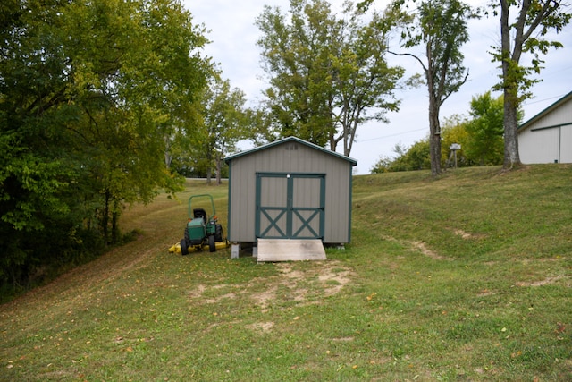 view of outbuilding featuring a yard