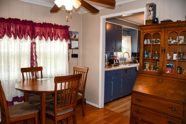 dining space featuring ornamental molding, hardwood / wood-style flooring, and ceiling fan