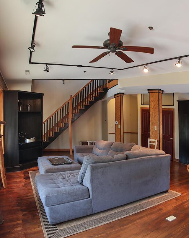 living room featuring track lighting, stairs, visible vents, ceiling fan, and wood finished floors