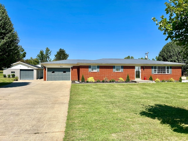 single story home with a garage and a front lawn