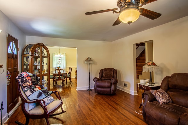 interior space with ceiling fan with notable chandelier and dark hardwood / wood-style floors