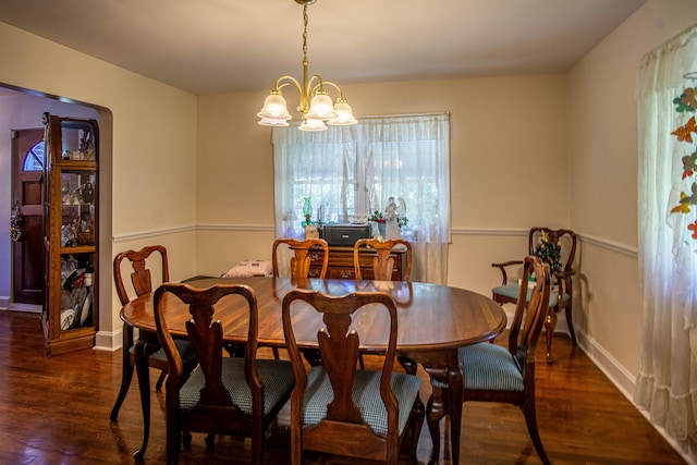 dining area featuring a notable chandelier and dark hardwood / wood-style floors