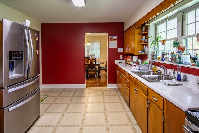 kitchen with light hardwood / wood-style flooring, stainless steel appliances, and sink