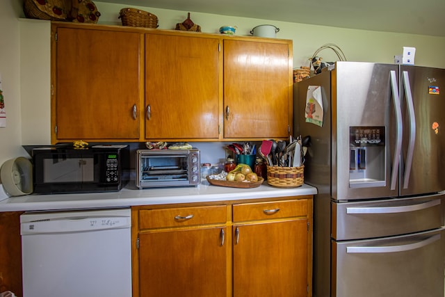 kitchen with white dishwasher and stainless steel refrigerator with ice dispenser