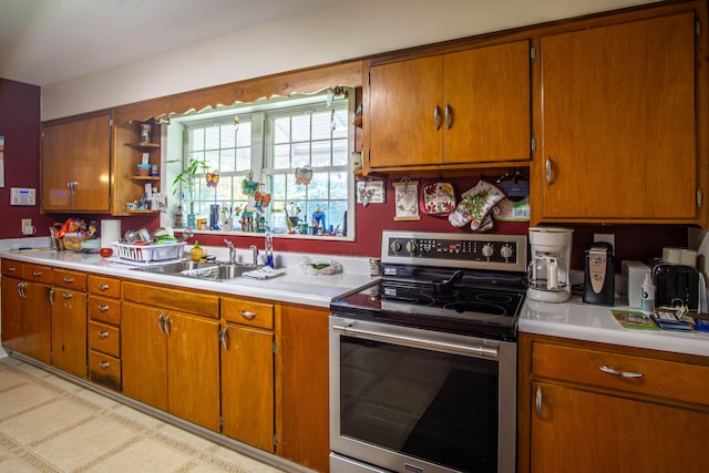 kitchen with stainless steel electric range and sink