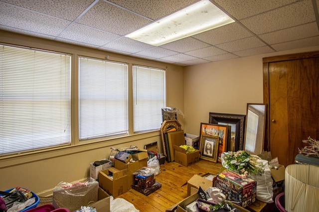 miscellaneous room with hardwood / wood-style floors and a paneled ceiling