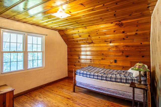 bedroom featuring wood ceiling, lofted ceiling, and hardwood / wood-style floors