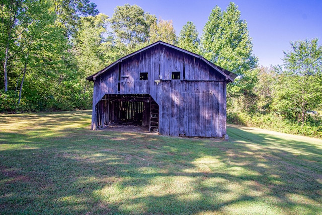 view of outbuilding with a lawn