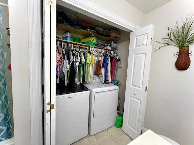 laundry room featuring washing machine and clothes dryer