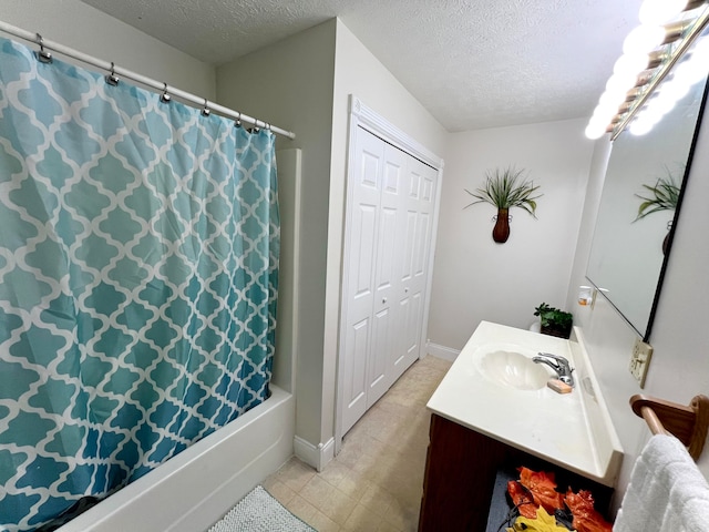 bathroom featuring a textured ceiling, vanity, and shower / tub combo with curtain