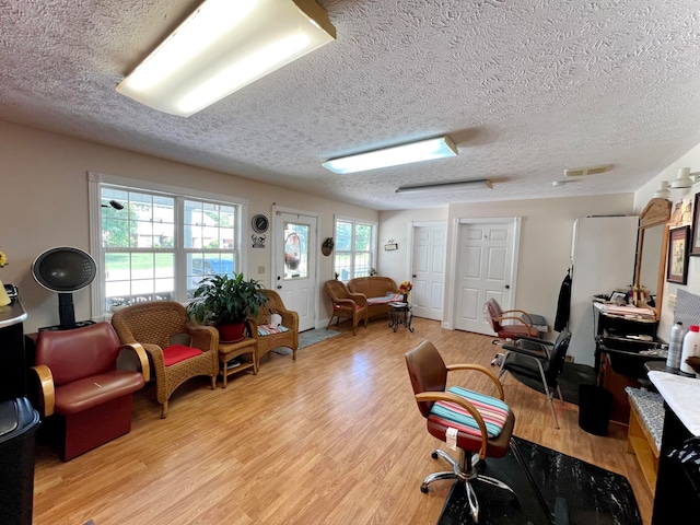 office space with a textured ceiling and light hardwood / wood-style floors