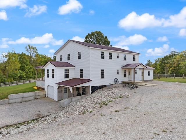 rear view of house with a garage