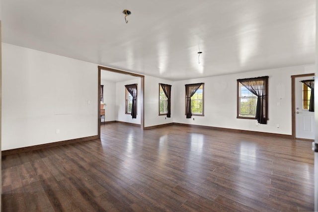 unfurnished living room featuring dark hardwood / wood-style flooring