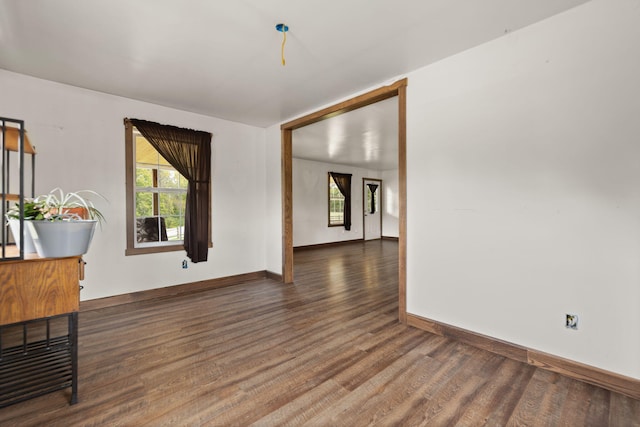 spare room with dark hardwood / wood-style floors