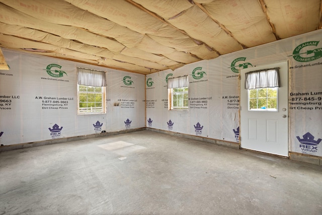 spare room featuring concrete floors and a wealth of natural light