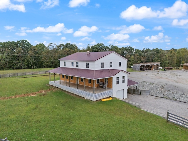 back of property with a lawn