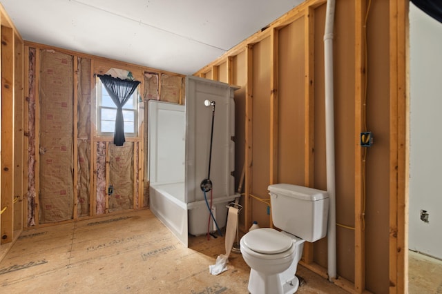 bathroom featuring a tub to relax in and toilet