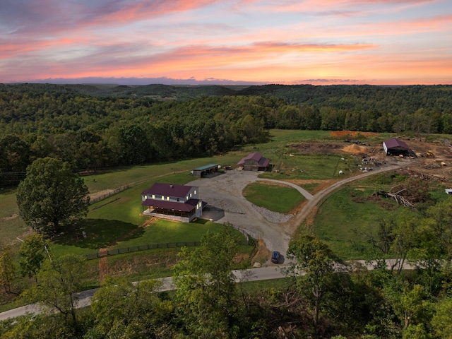 aerial view at dusk featuring a rural view