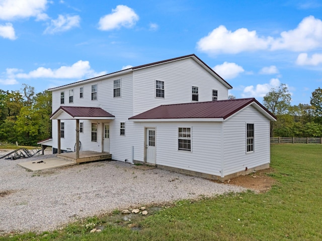 rear view of house with a yard and a wooden deck