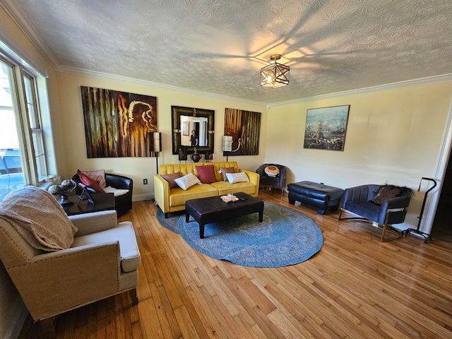 living room featuring hardwood / wood-style floors, a textured ceiling, and ornamental molding