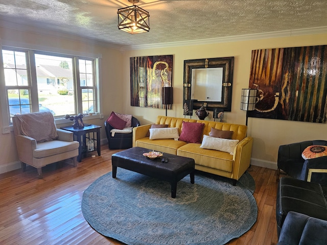 living room with ornamental molding, a textured ceiling, and wood-type flooring