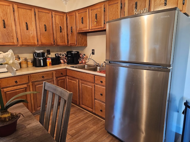 kitchen featuring stainless steel fridge, sink, and dark hardwood / wood-style floors