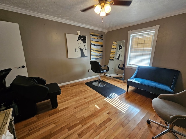 interior space with crown molding, a textured ceiling, wood-type flooring, and ceiling fan