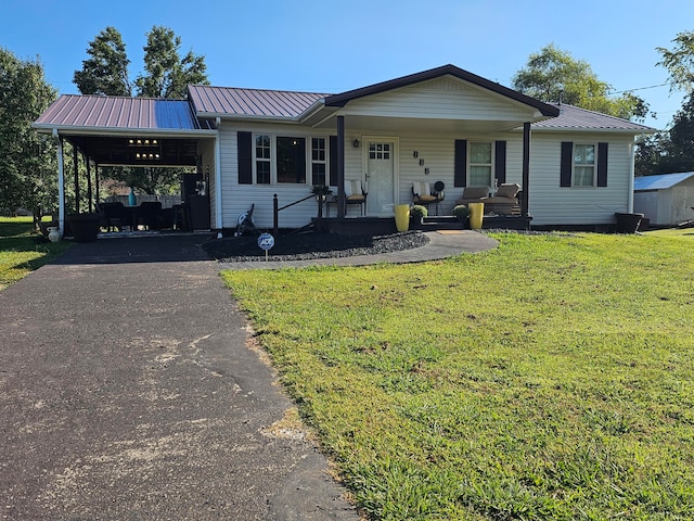 ranch-style home with a shed, covered porch, and a front lawn