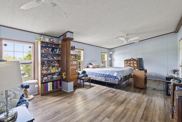 bedroom featuring hardwood / wood-style floors, ceiling fan, and ornamental molding