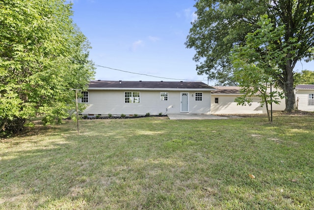 rear view of house with a yard and a patio