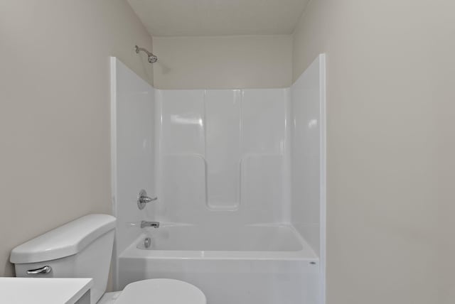 full bathroom featuring toilet, bathing tub / shower combination, and vanity