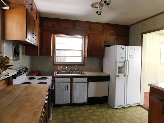 kitchen with crown molding, wooden counters, sink, and white appliances