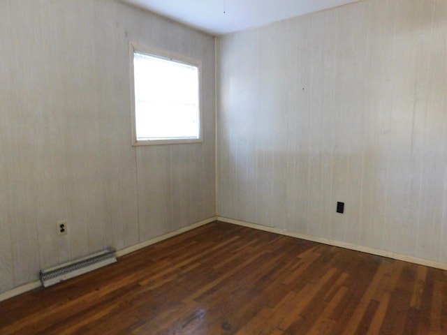 empty room with dark hardwood / wood-style flooring