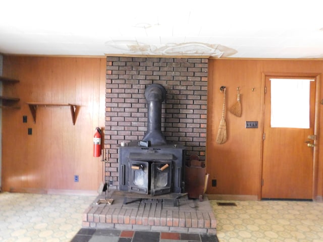 details with a wood stove and wooden walls