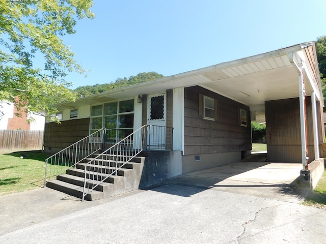 single story home featuring a carport