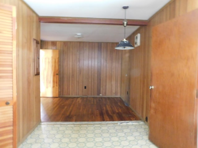 unfurnished dining area featuring hardwood / wood-style floors and wood walls