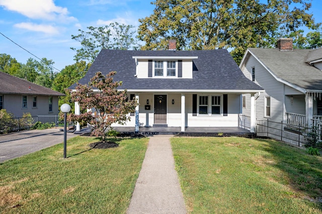 bungalow-style house with a front yard and covered porch