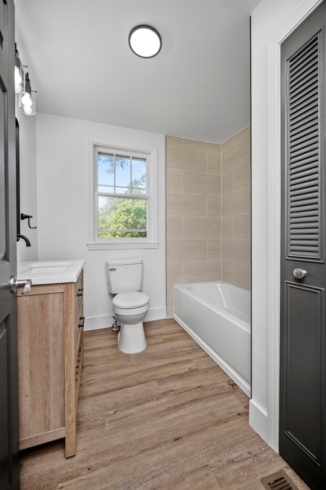 bathroom with vanity, toilet, and hardwood / wood-style flooring