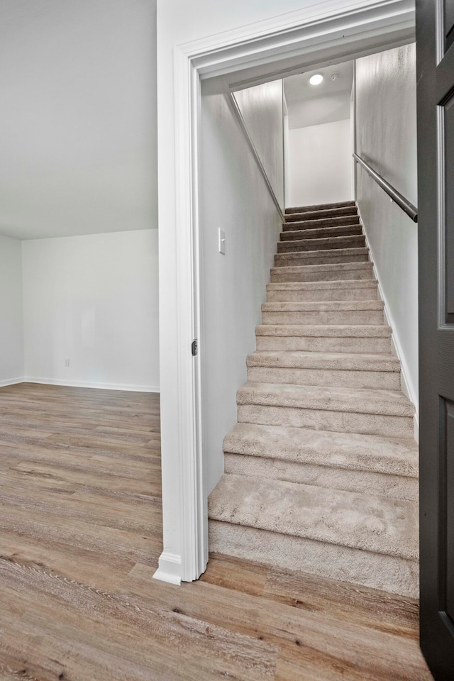 stairs featuring wood-type flooring