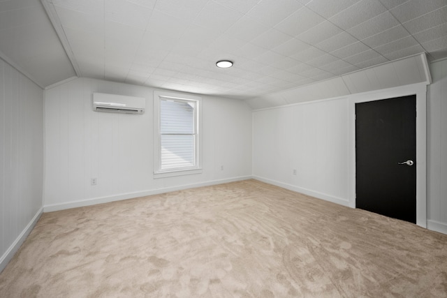 empty room featuring a wall mounted AC, vaulted ceiling, and carpet floors