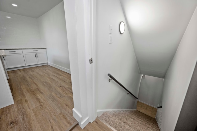 staircase featuring wood-type flooring