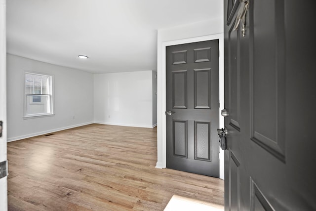 foyer entrance with light wood-type flooring