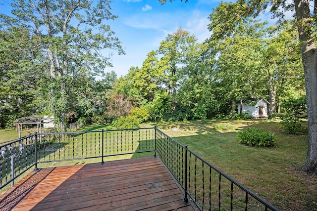 wooden terrace featuring a lawn